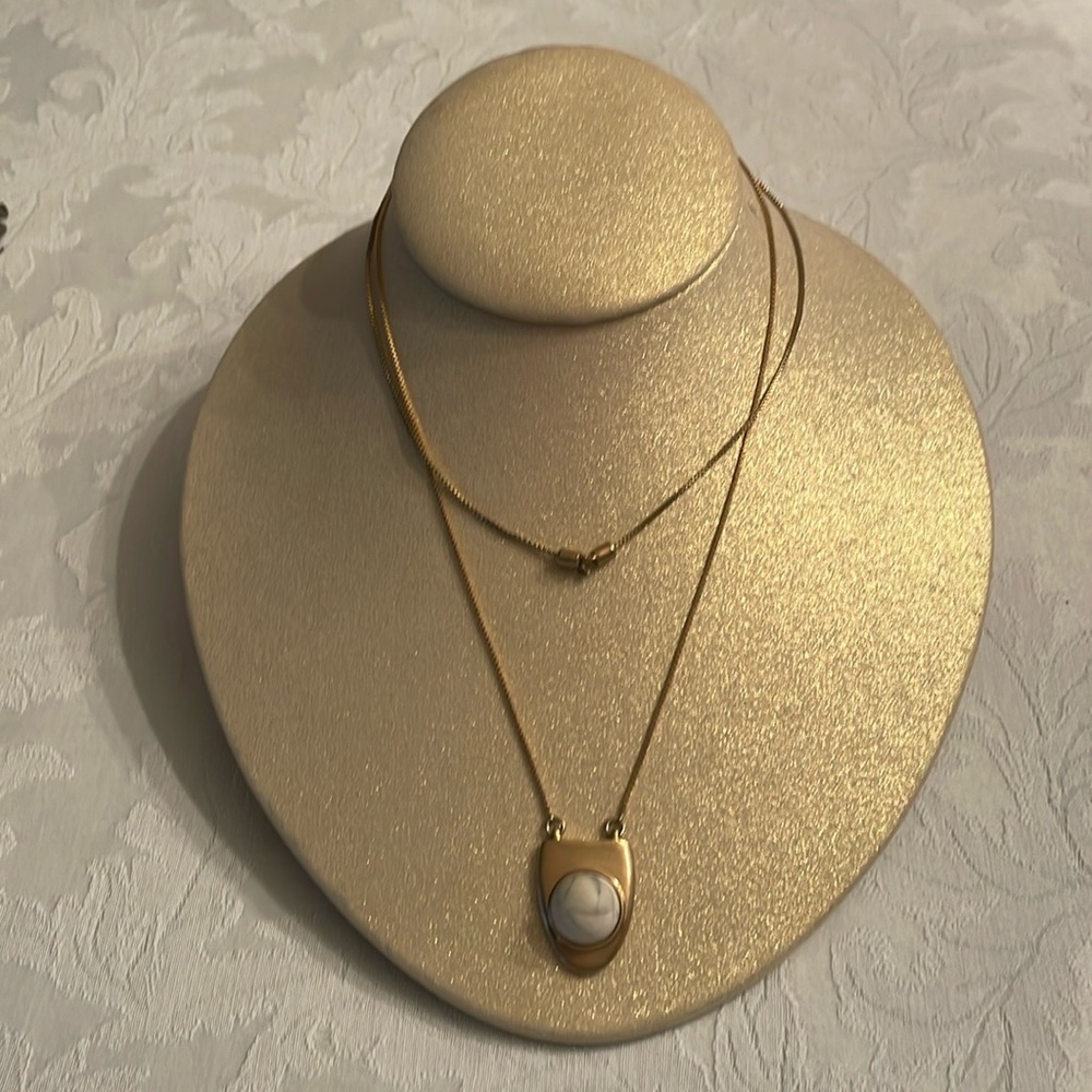 17 inch long pendant in gold with a center stone